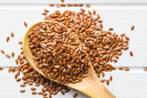 a wooden spoon with flaxseed